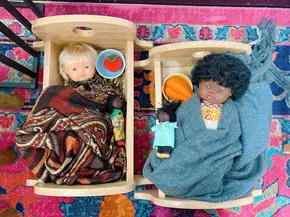 Waiting Baby dolls in a cot