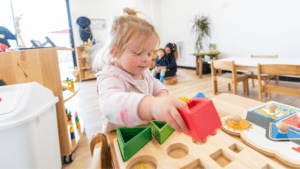 Waiting Child playing with shaped blocks