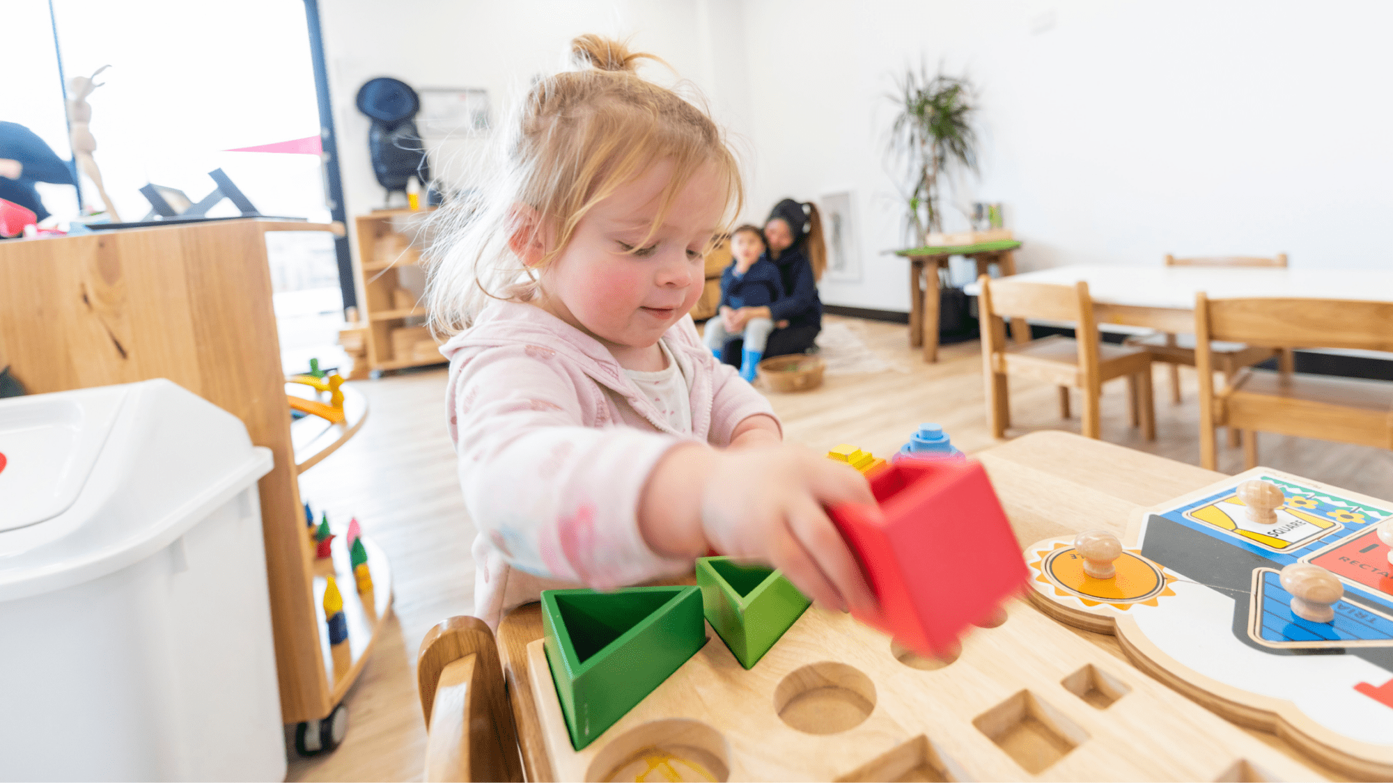 Child playing with shaped blocks
