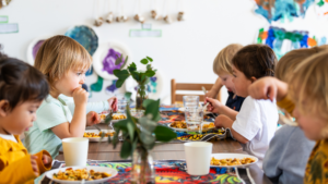 Waiting Young children eating around a table