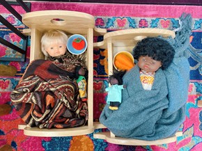 Baby dolls in a cot
