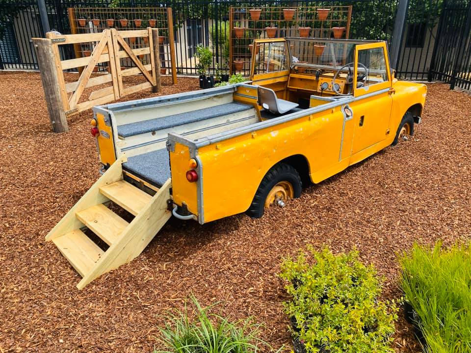 Outdoor space at Conder Early Learning Centre with a life size ute for children to explore.